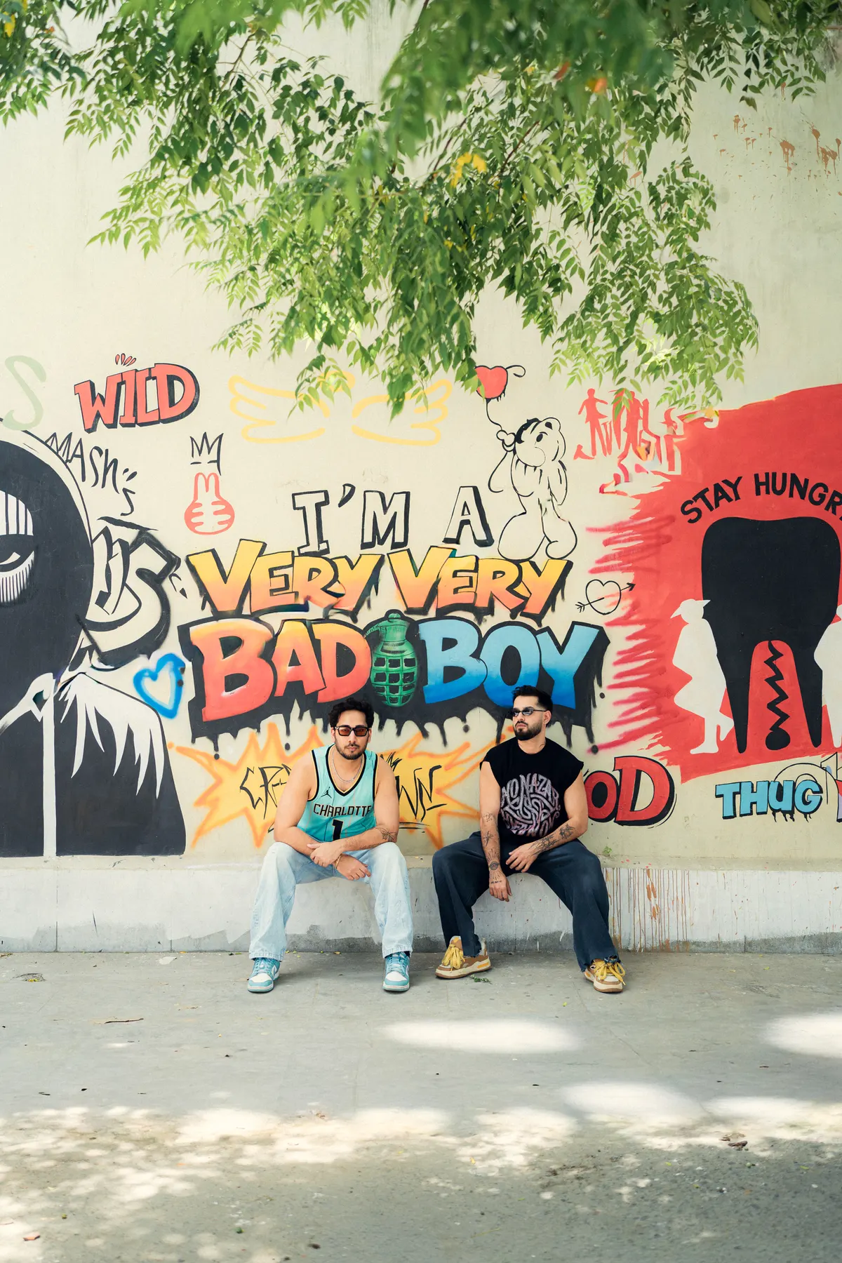 Seated in front of a graffiti wall